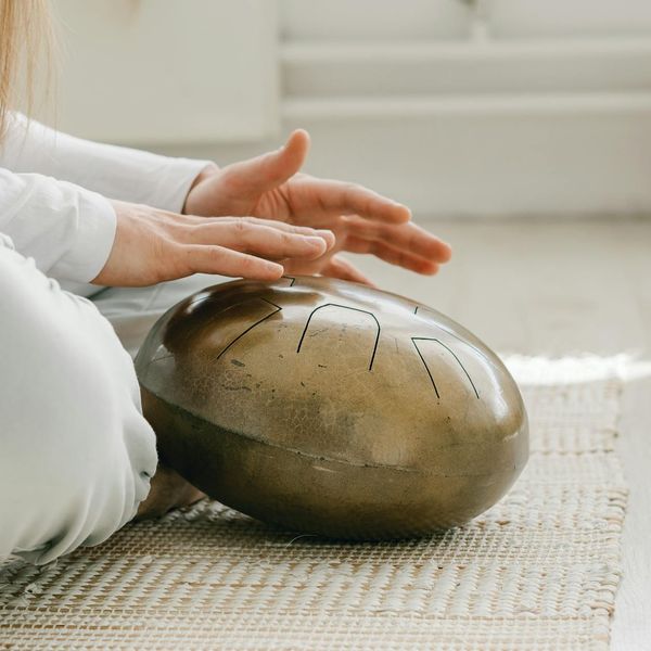 A person smiling gently, looking refreshed and calm after a wellness practice.