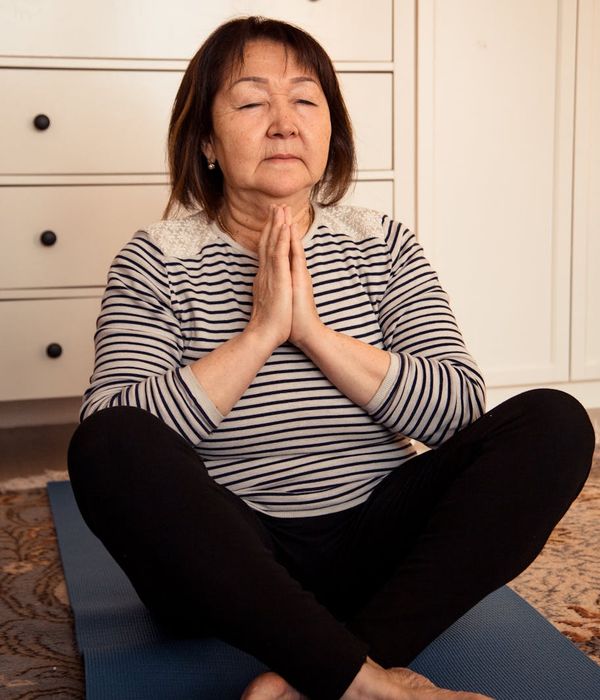 Woman peacefully closing her eyes, focusing on inner calm and well-being.